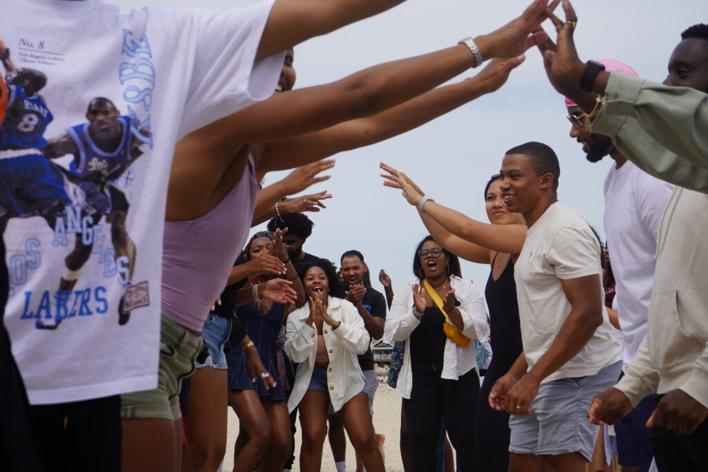 A group of people in a circle with their arms raised