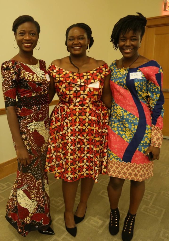 Three women in colorful dresses. 