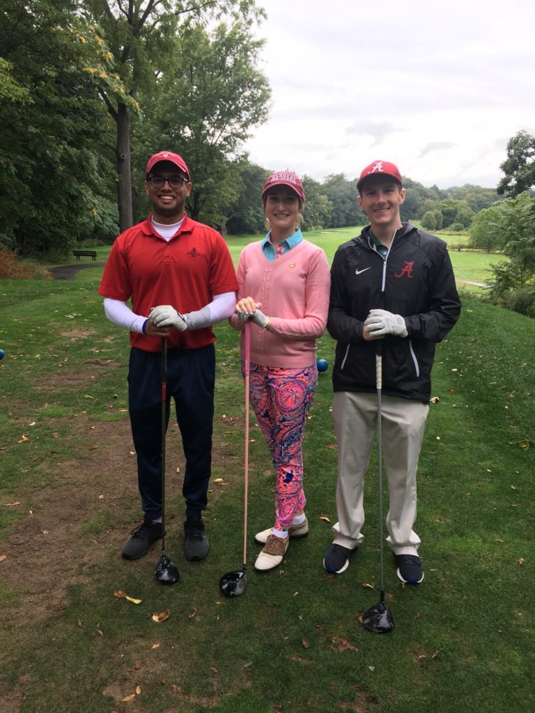 Three people on golf course.