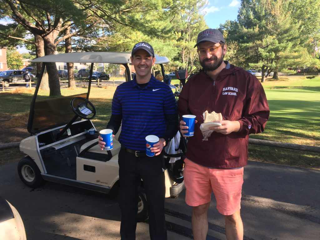 Men holding beverages.