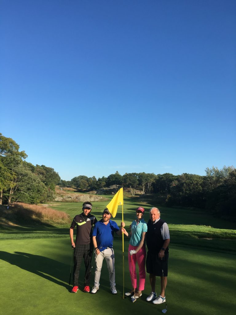 People standing on golf course.