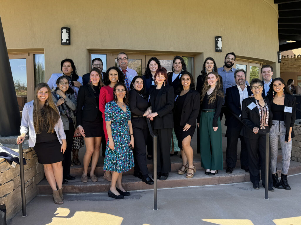 Group of people standing outside building. 
