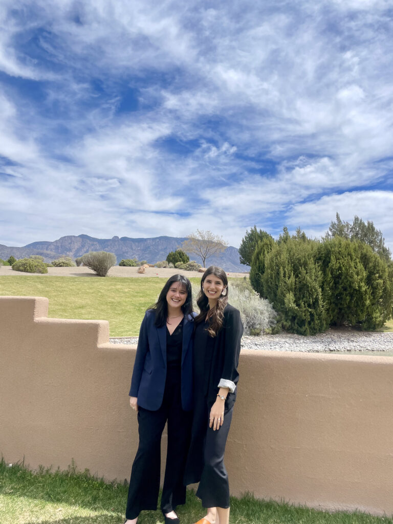Two women with mountains in the background.