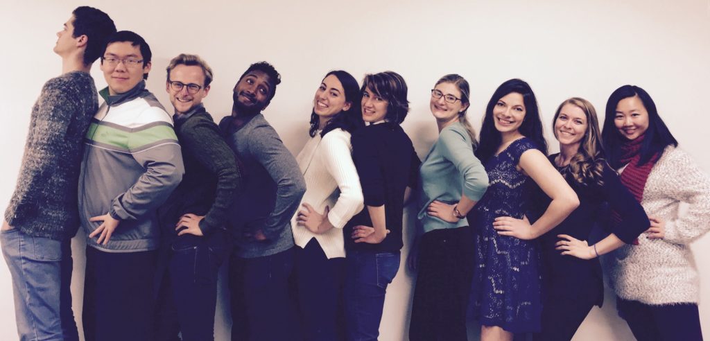 People posing with arms out. 