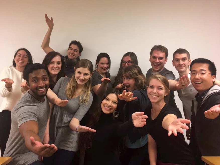 Scales members holding out hands. 